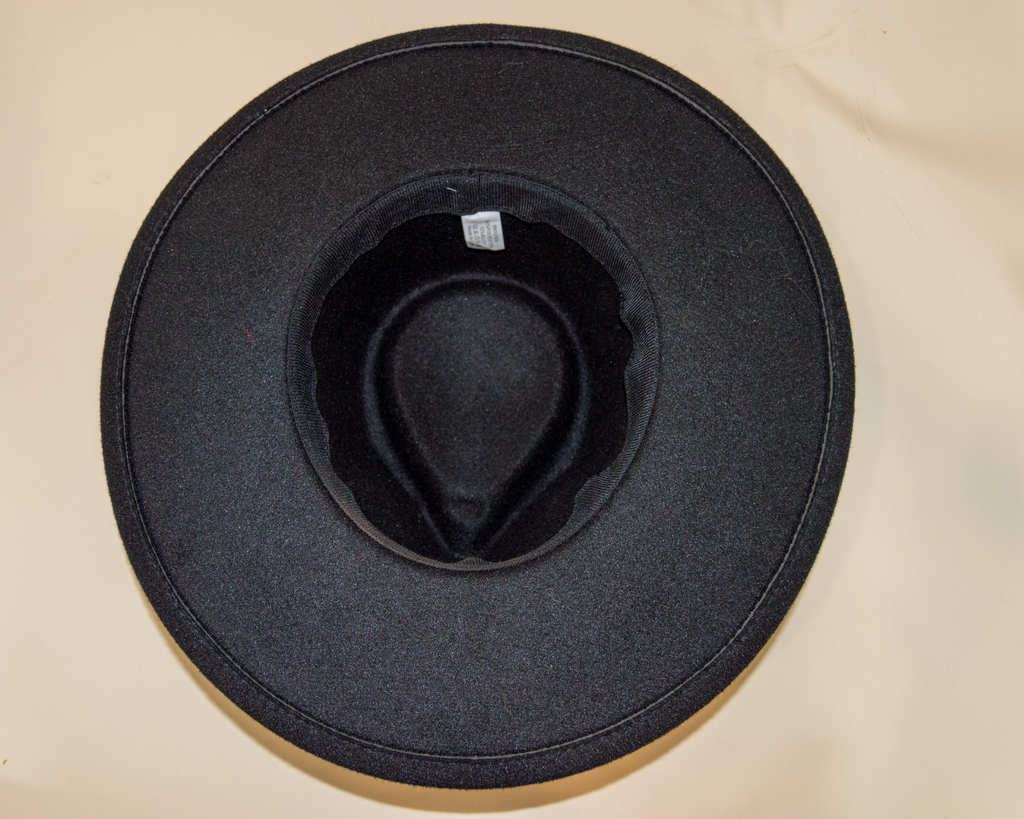 Black hat on a beige surface