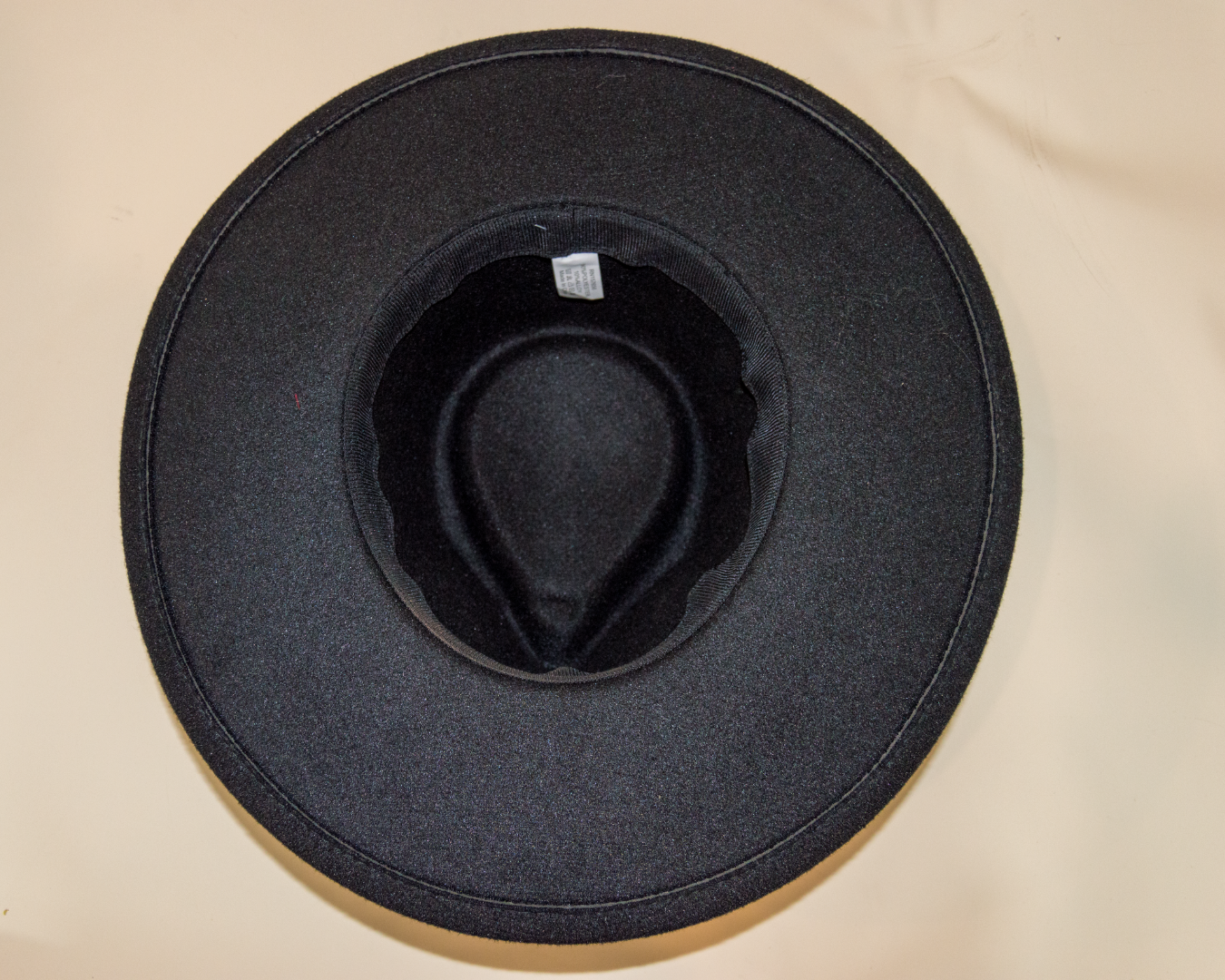 Black hat on a beige surface