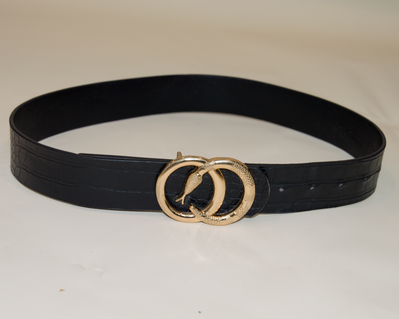 Black belt with a gold buckle on a white background