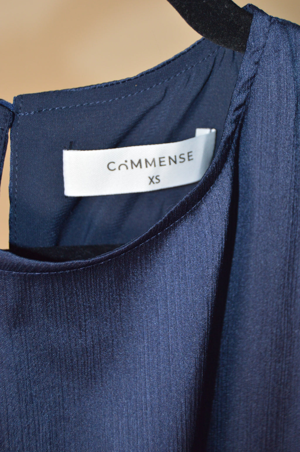 Navy blue fabric with a visible brand label on a beige background