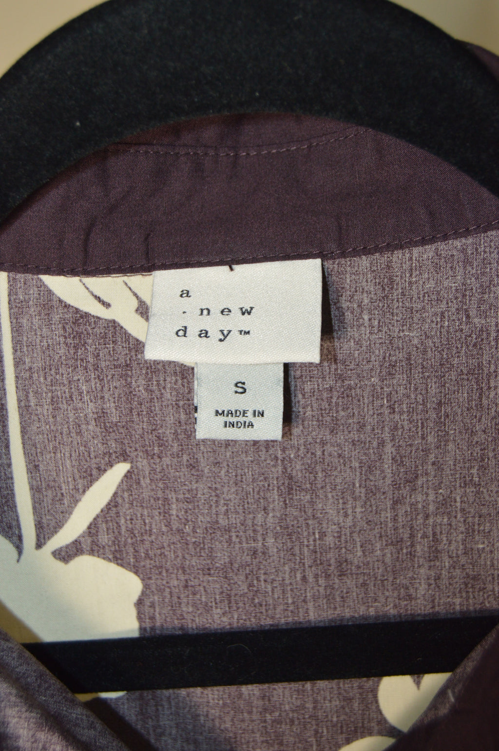 Close-up of a garment with a label on a brown background