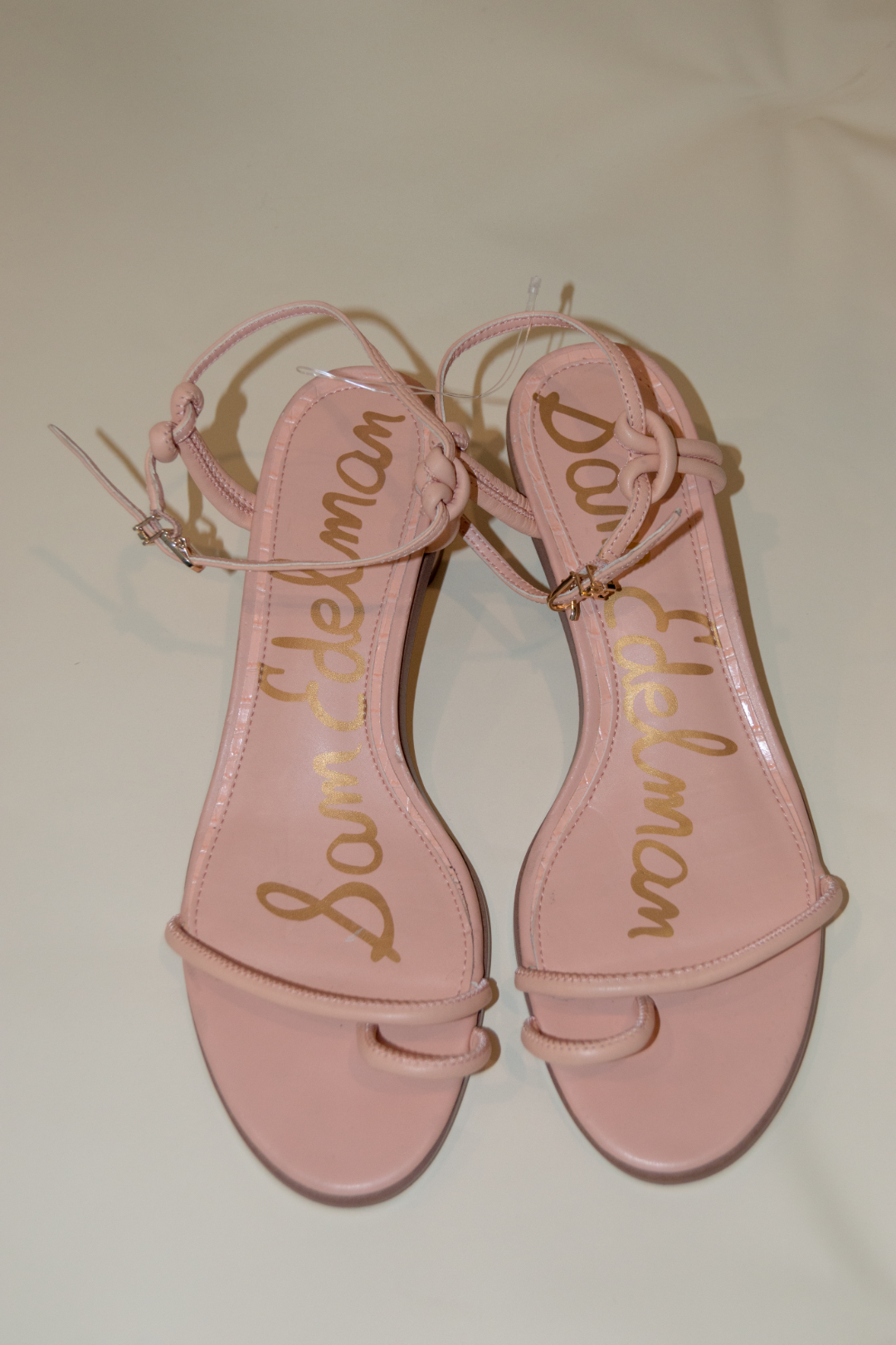 Pink sandals with 'Sam Edelman' branding on a light background
