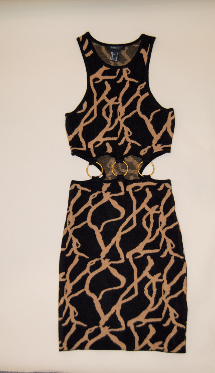 Black and brown patterned sleeveless dress on a beige background