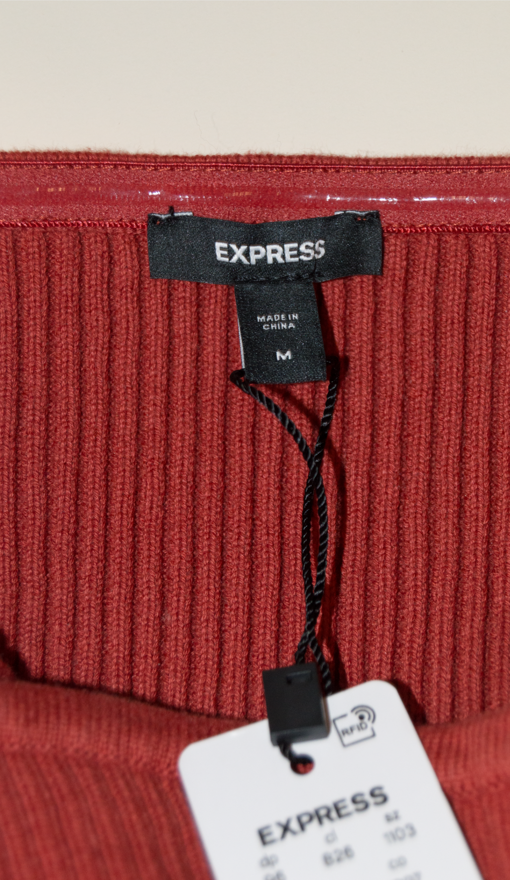 Red ribbed fabric with Express tags on a white background