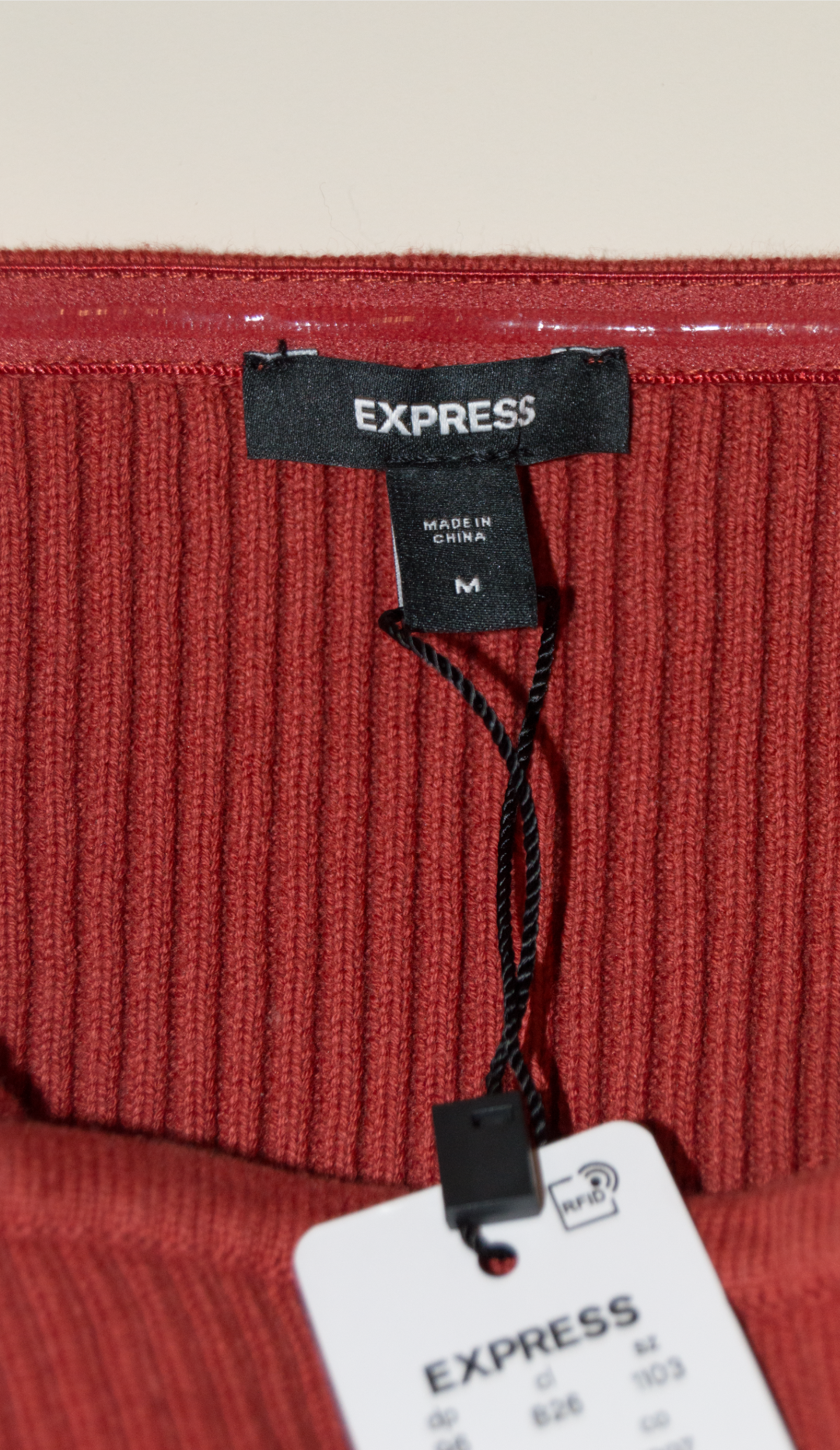 Red ribbed fabric with Express tags on a white background