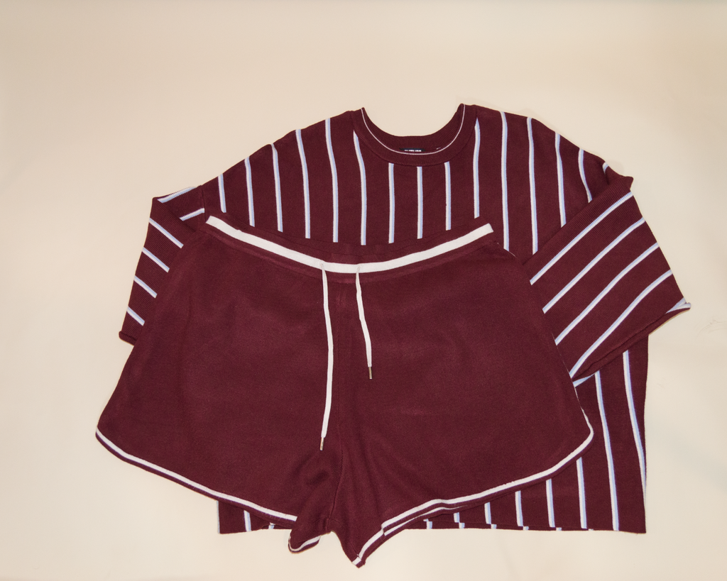 Maroon and white striped shirt ans shorts 
on a beige background