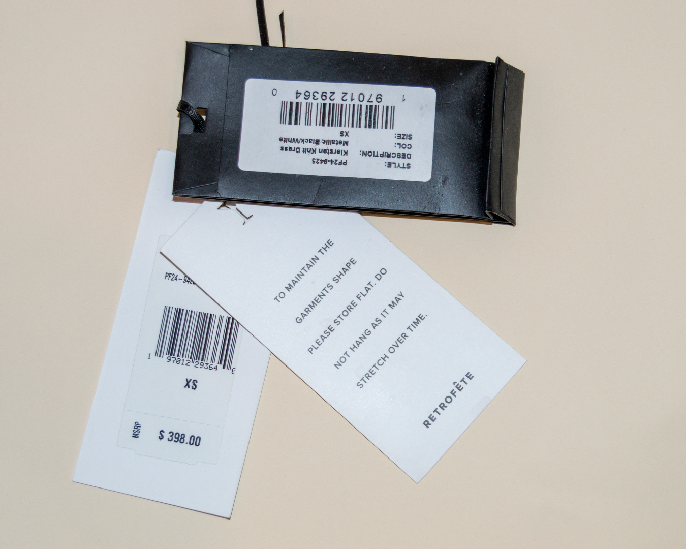 Black rectangular device with a barcode label on a beige background
