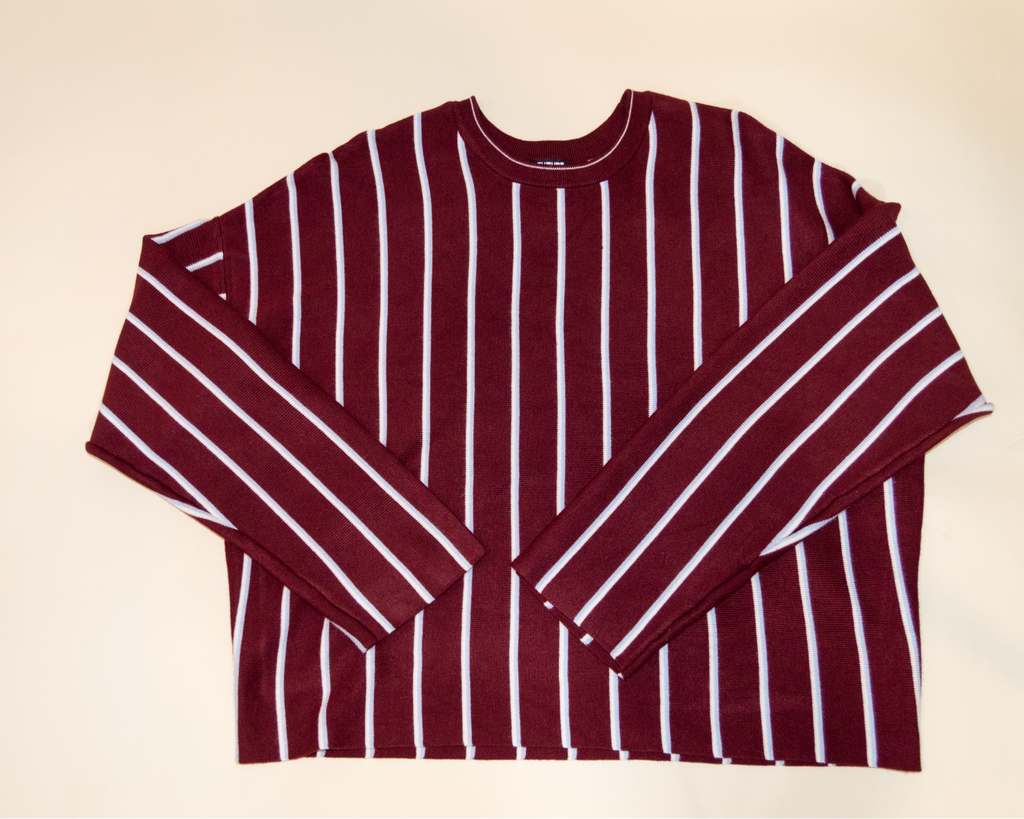 Maroon and white striped shirt on a beige background