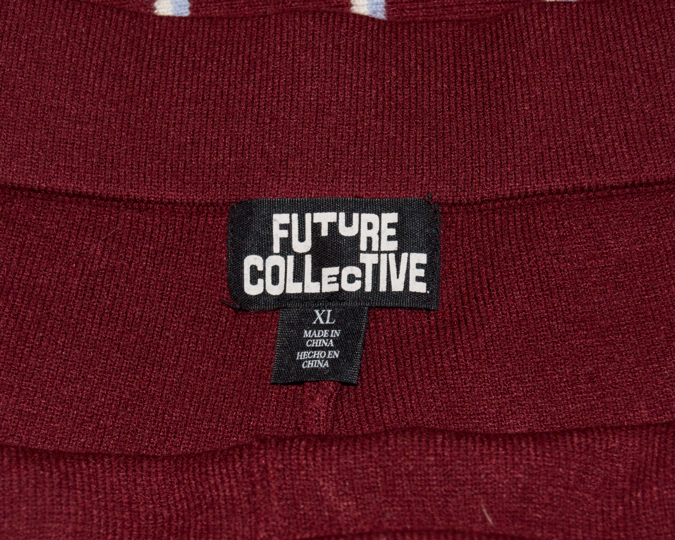 Close-up of a maroon fabric with a 'Future Collective' label.