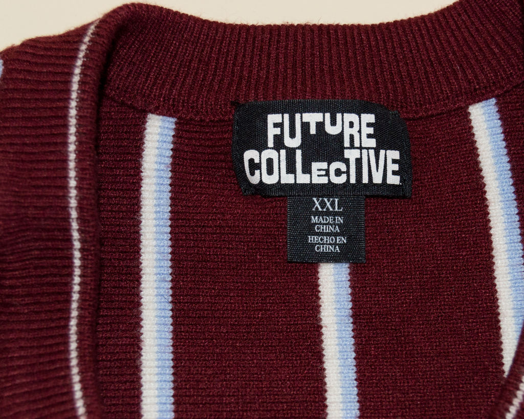 Maroon sweater with white and light blue stripes and 'Future Collective' label.